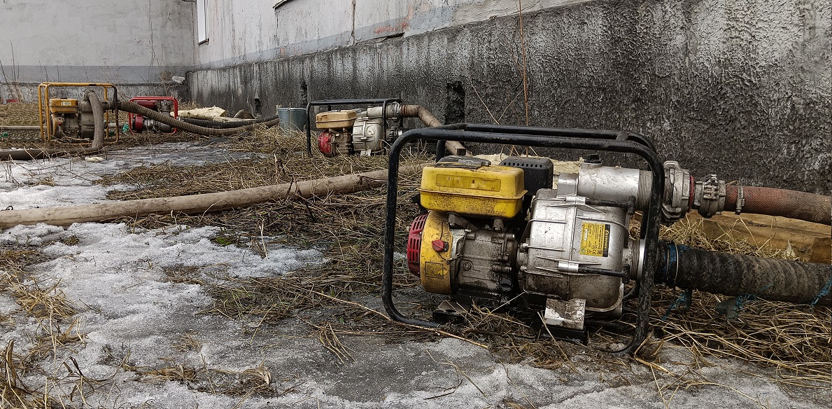 Откачка мотопомпами талой воды из подвала дома в Курской области